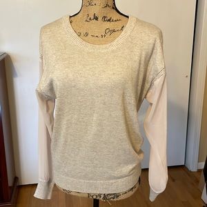 Cream sweater with sheer sleeves and backwards v neck